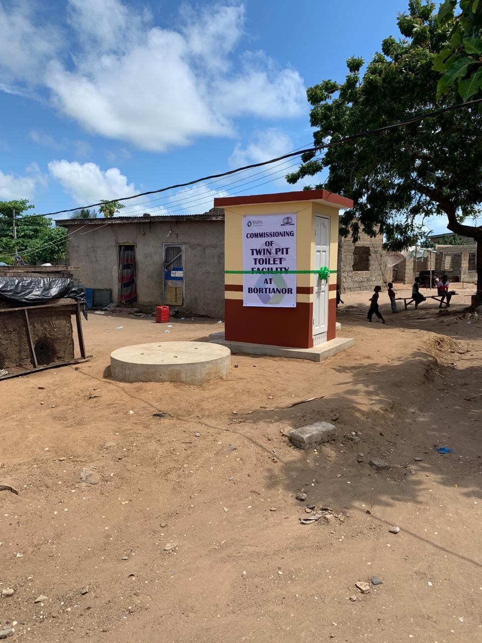 A newly built household toilet in the village, carrying a banner announcing the commissioning of a twin pit toilet facility at Bortianor